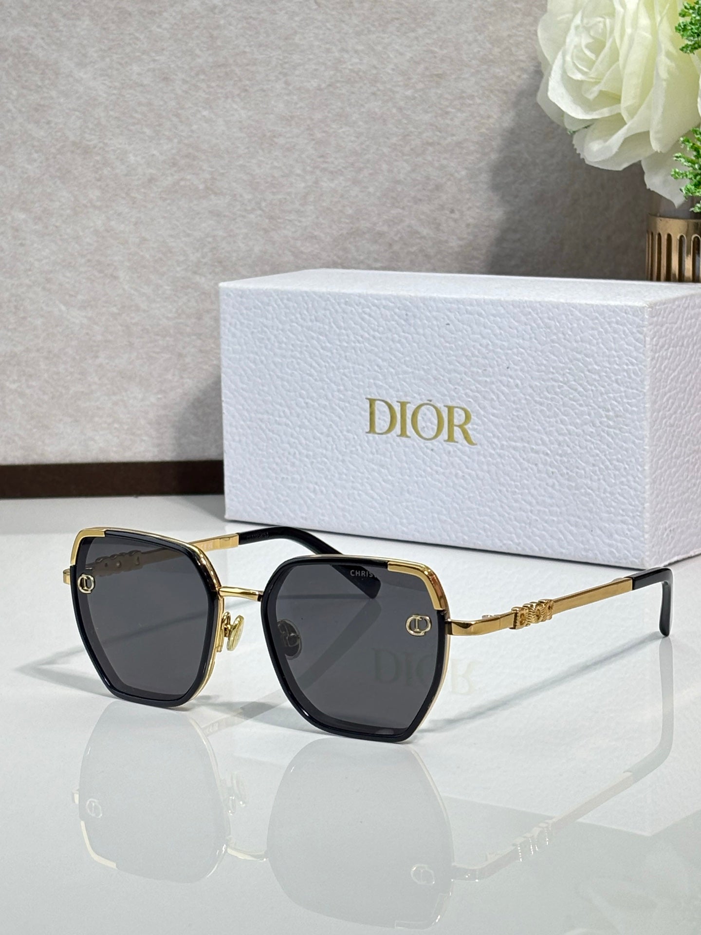 Dior sunglasses with dark lenses and gold-tone oversized square frames