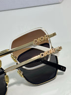Dior sunglasses close-up with gold “Dior” detail on temples and dark lenses