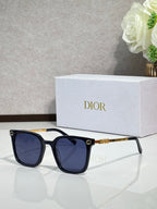 Sunglasses by Dior with dark frames, dark lenses, and gold temple accents