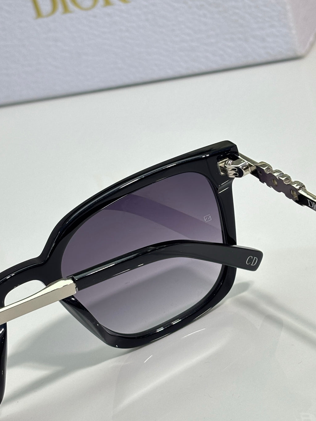 Sunglasses by Dior close-up with black frame and dark gradient lens