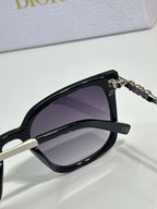 Sunglasses by Dior close-up with black frame and dark gradient lens