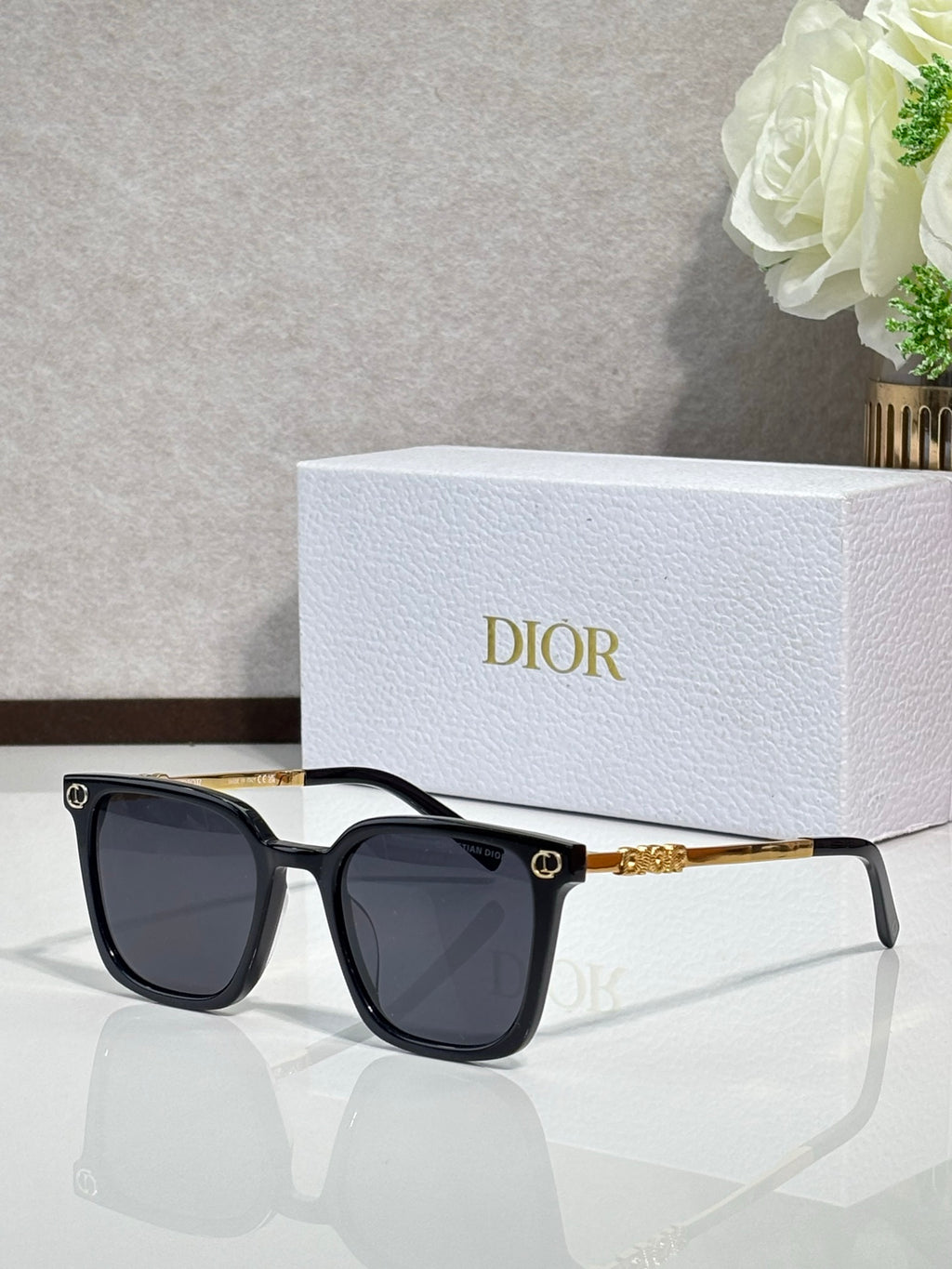 Sunglasses by Dior with black cat-eye frames and dark lenses