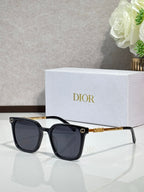 Sunglasses by Dior with black cat-eye frames and dark lenses