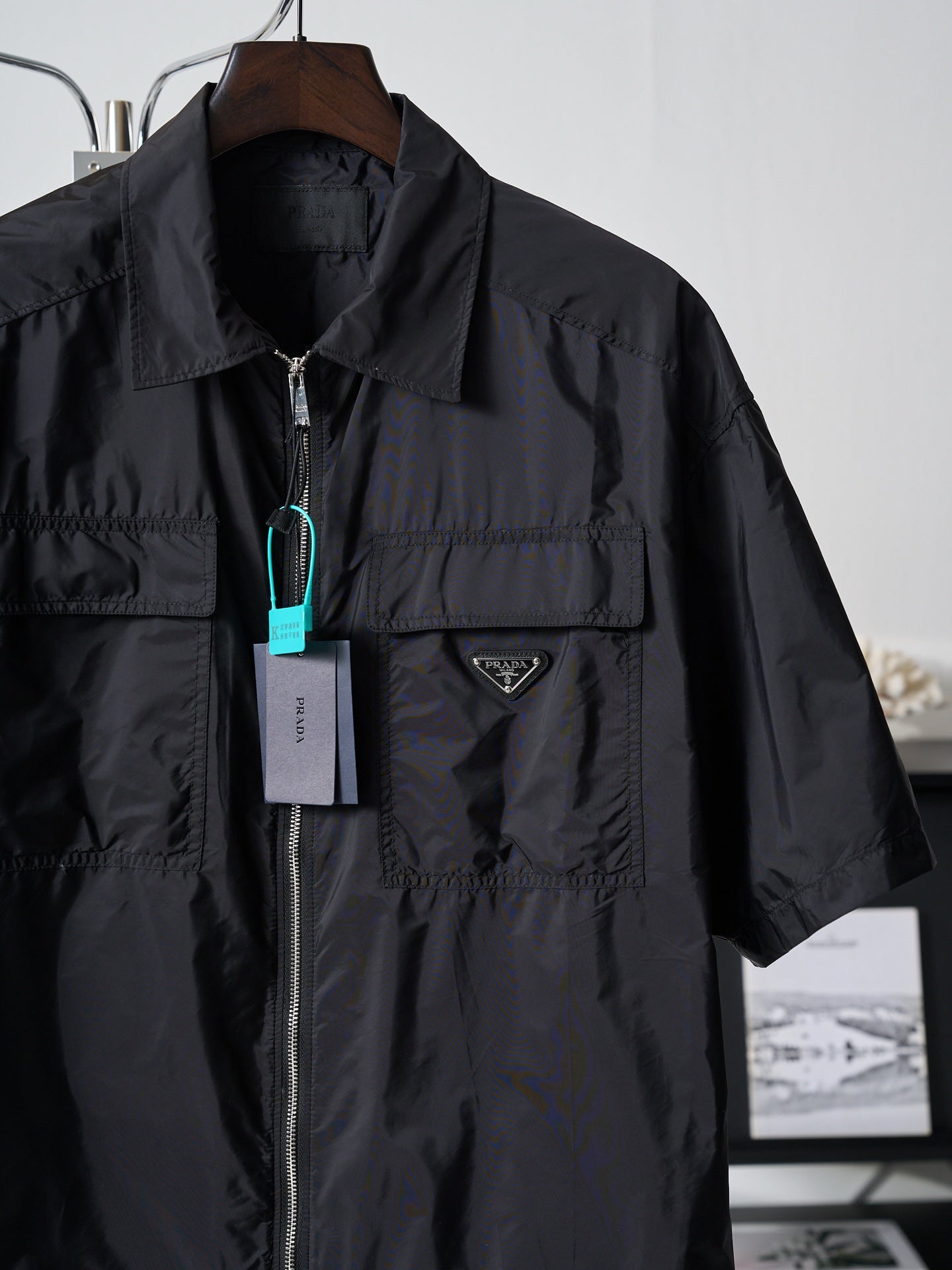 Prada dark short jacket with front zipper and triangular logo patch