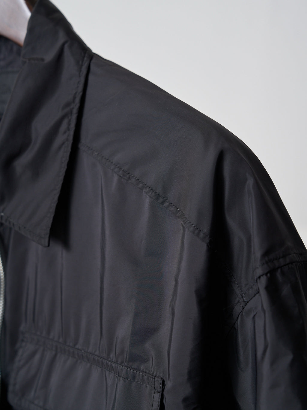 Prada dark short jacket shoulder and sleeve seam detail
