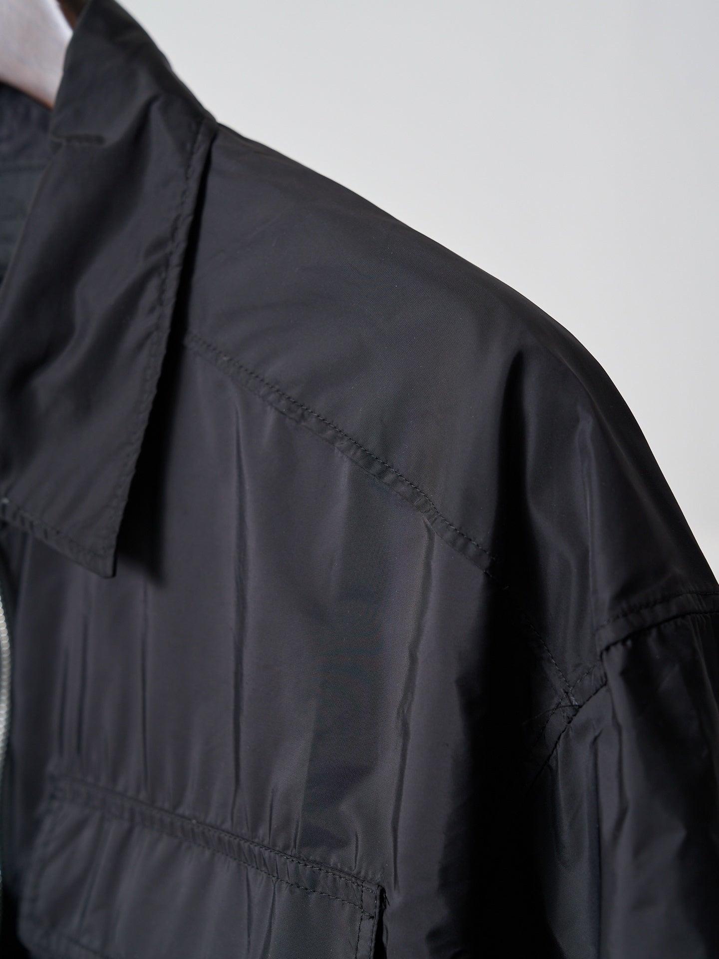 Prada dark short jacket shoulder and sleeve seam detail
