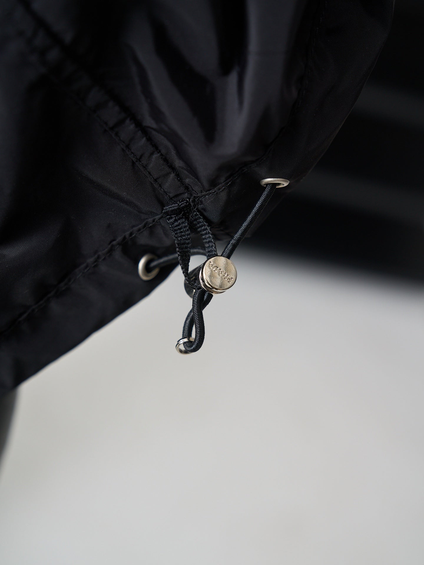 Prada dark jacket hem drawstring with metal toggle