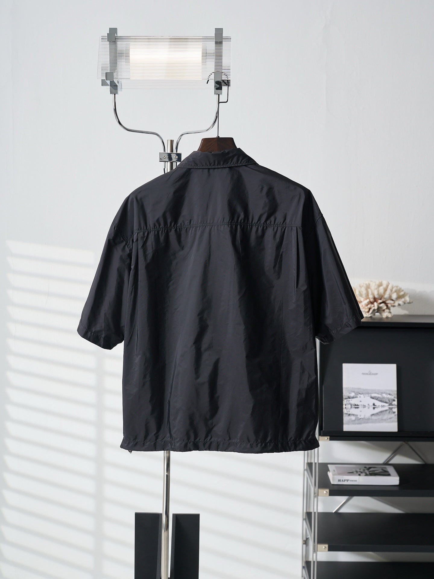 Prada dark short jacket back view with high stand collar