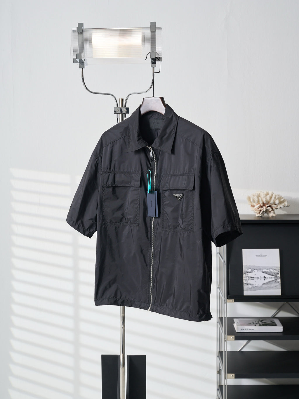 Prada dark short jacket front view with stand collar and zip closure