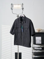 Prada dark short jacket front view with stand collar and zip closure