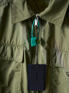 Olive green Prada jacket front zipper with hanging tags and metal pull