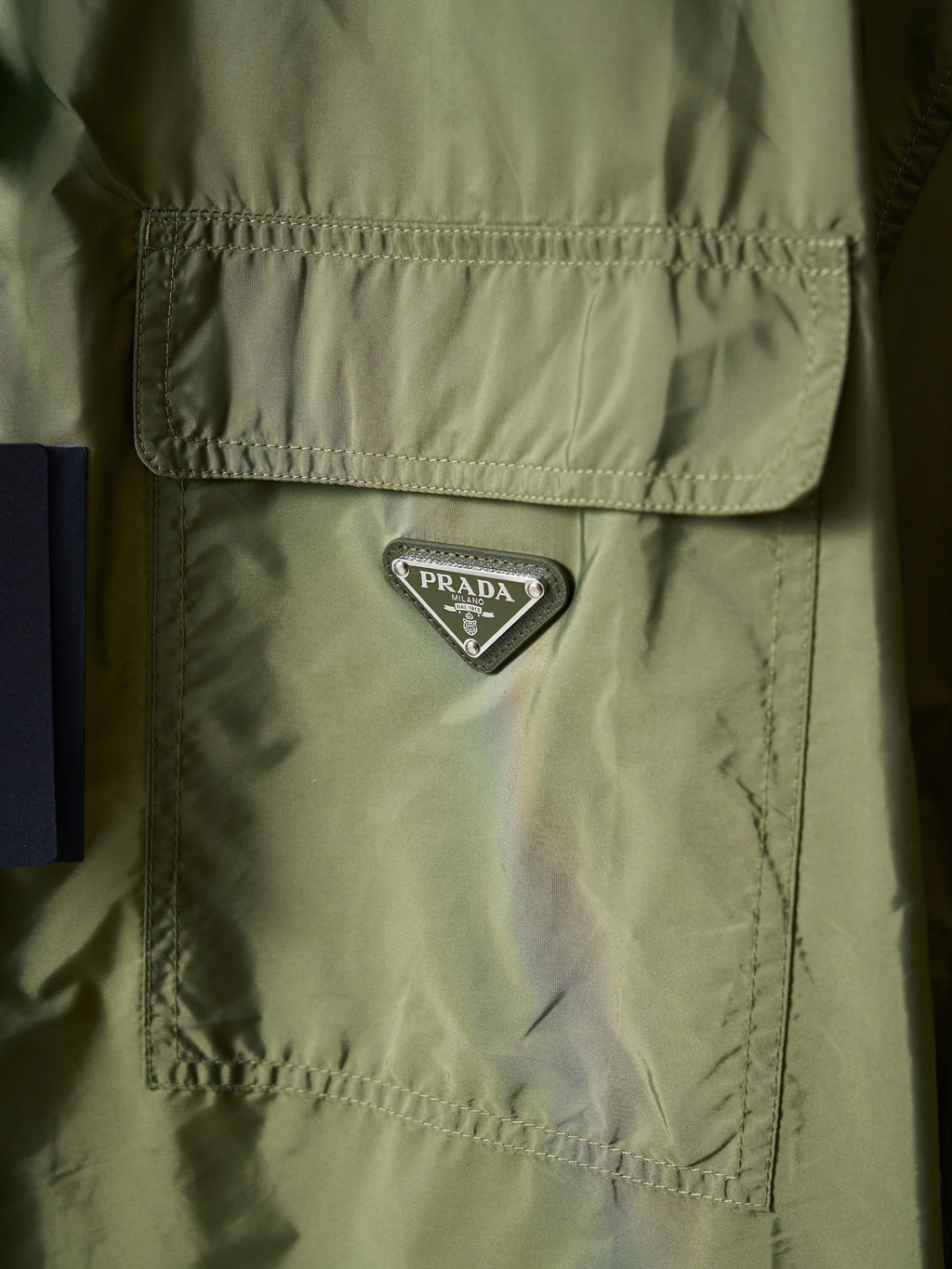 Olive green Prada jacket chest logo triangle patch on flap pocket