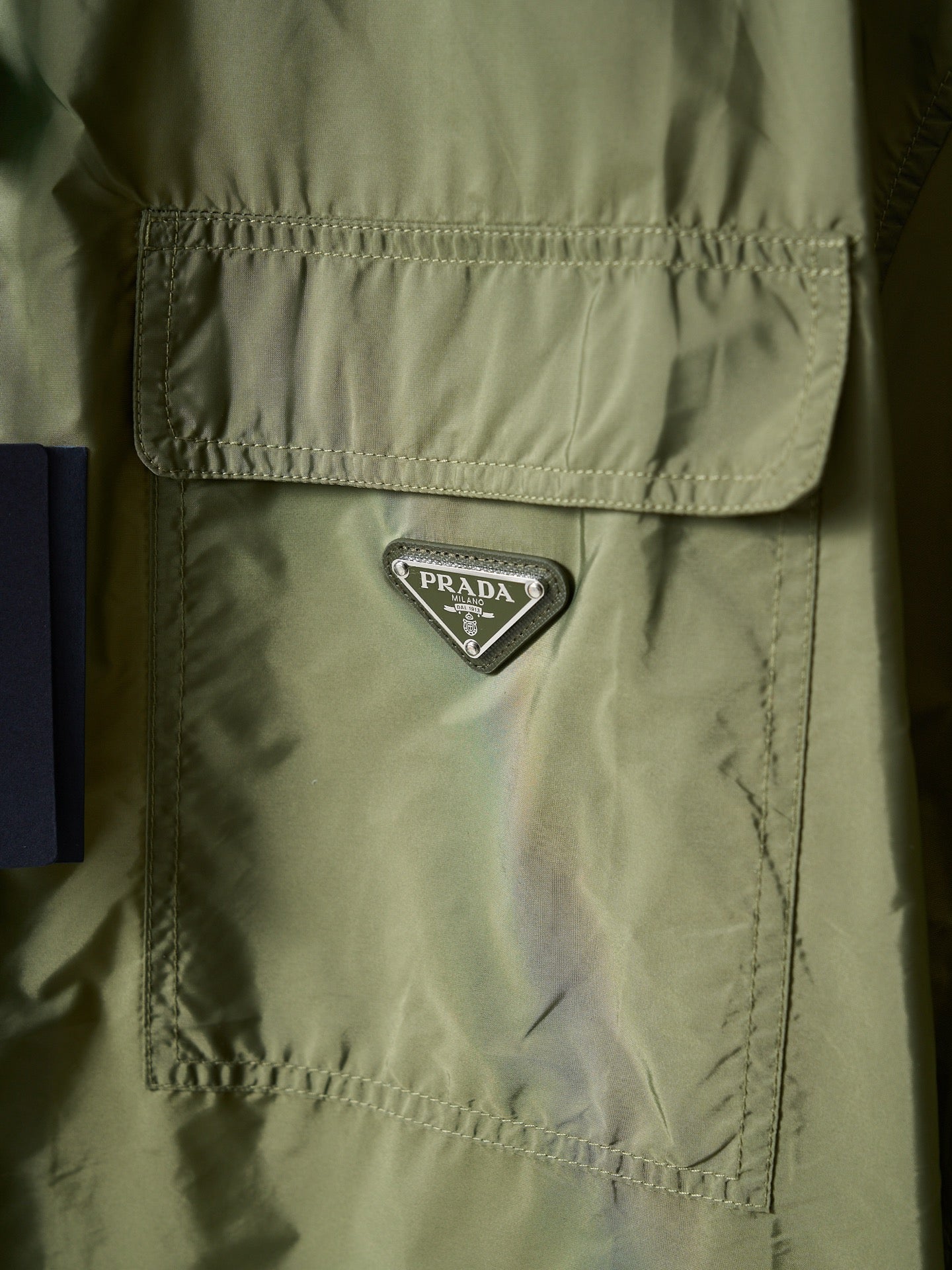 Olive green Prada jacket chest logo triangle patch on flap pocket