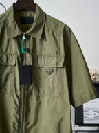 Olive green Prada short-sleeve jacket with stand collar, zip front, and logo patch