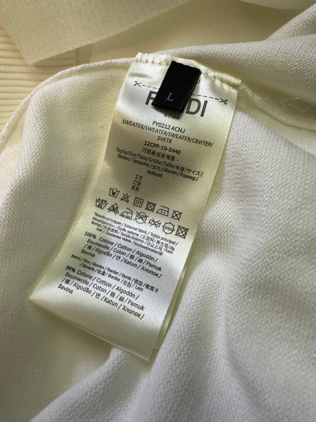 Fendi sweater care label on cream knit fabric