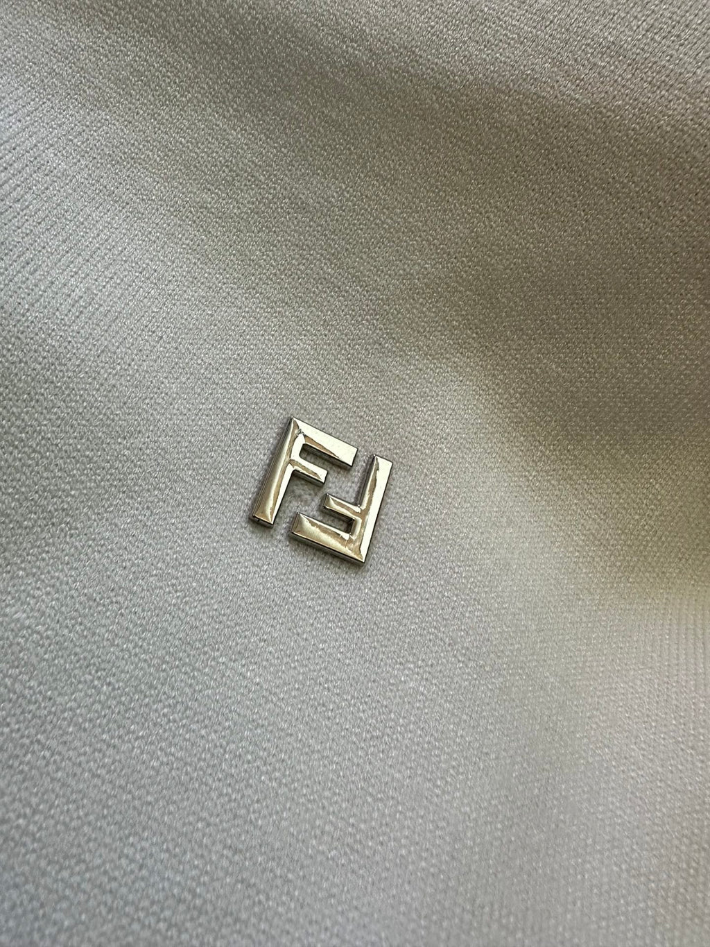 Fendi logo patch on cream knit sweater fabric