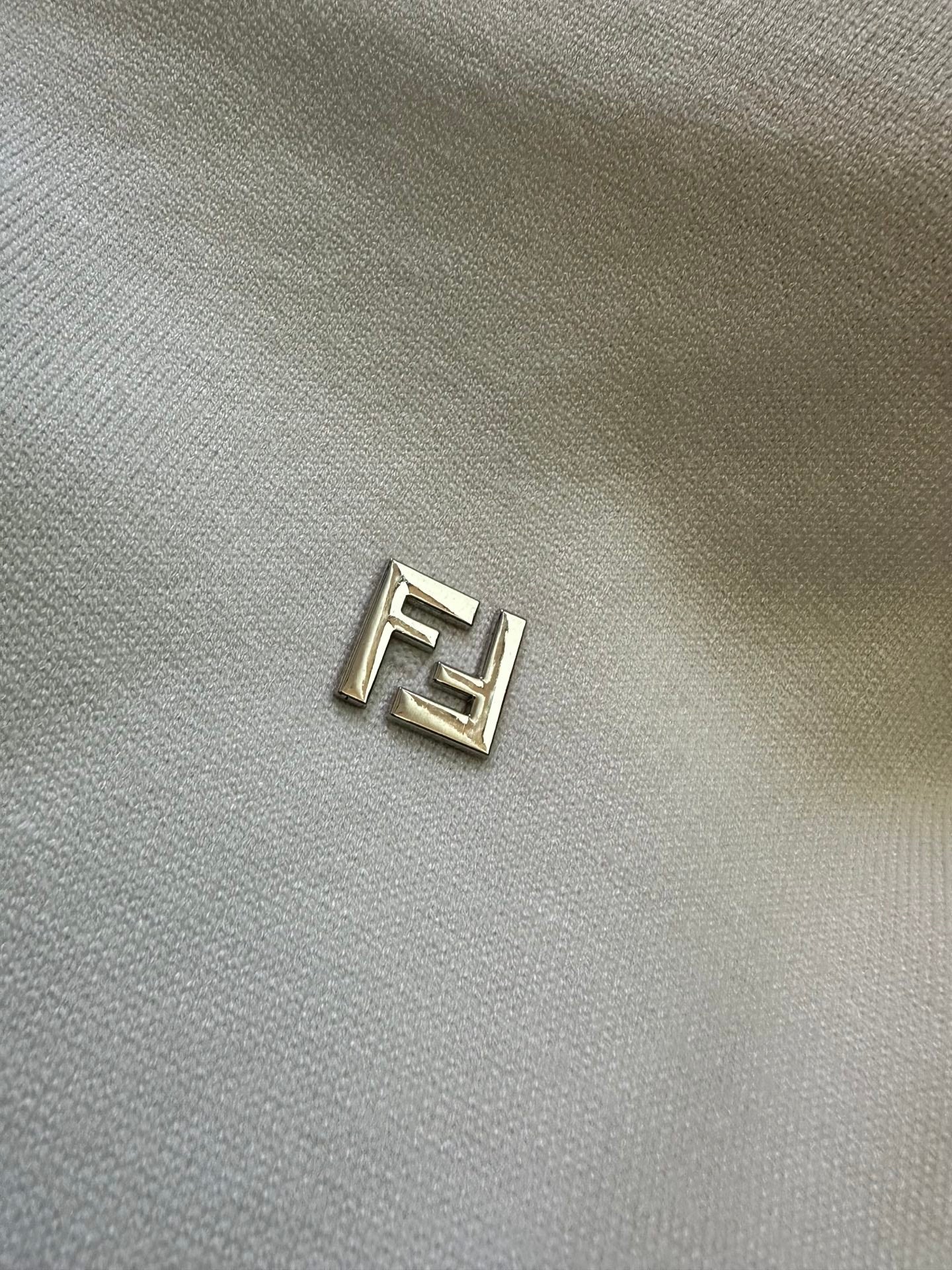 Fendi logo patch on cream knit sweater fabric