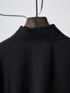 Back yoke of black polo shirt on hanger with fabric texture