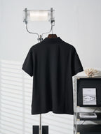 Black Prada polo shirt with stand collar and short sleeves on hanger