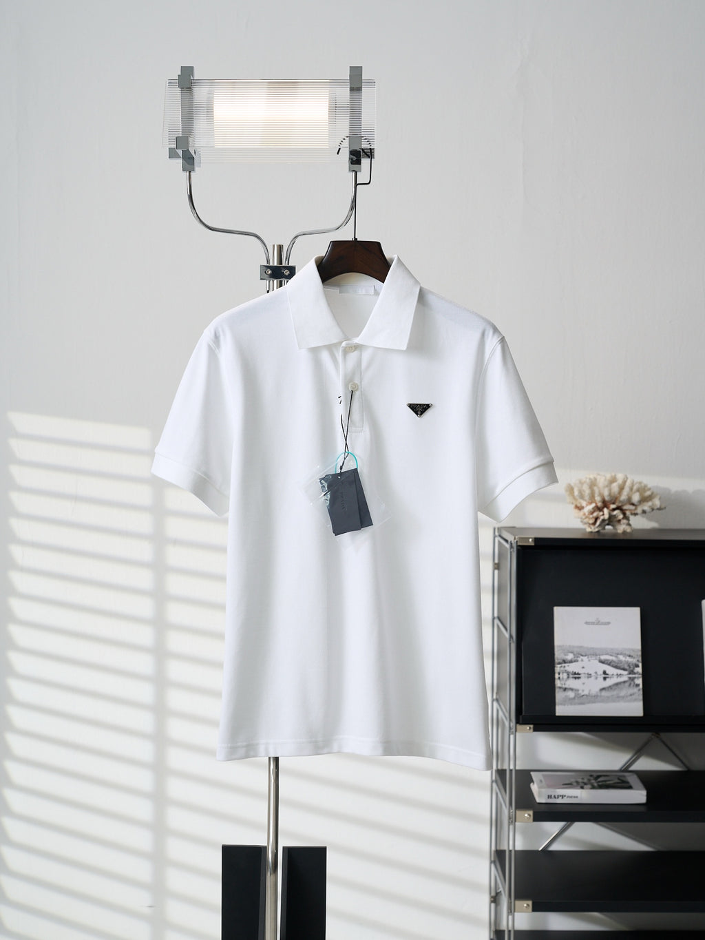 White short-sleeve polo shirt with button placket and PRADA logo on chest