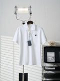 White short-sleeve polo shirt with button placket and PRADA logo on chest