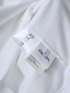 Care label and PRADA tag on white polo shirt interior seam