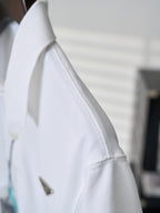 White polo shirt sleeve with textured fabric and small logo detail