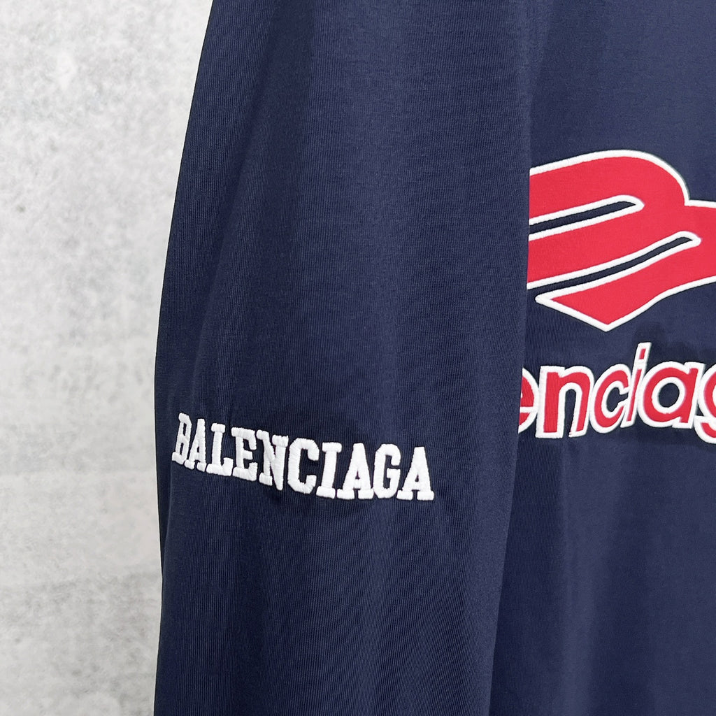Balenciaga navy sleeve with Balenciaga text print and part of red logo