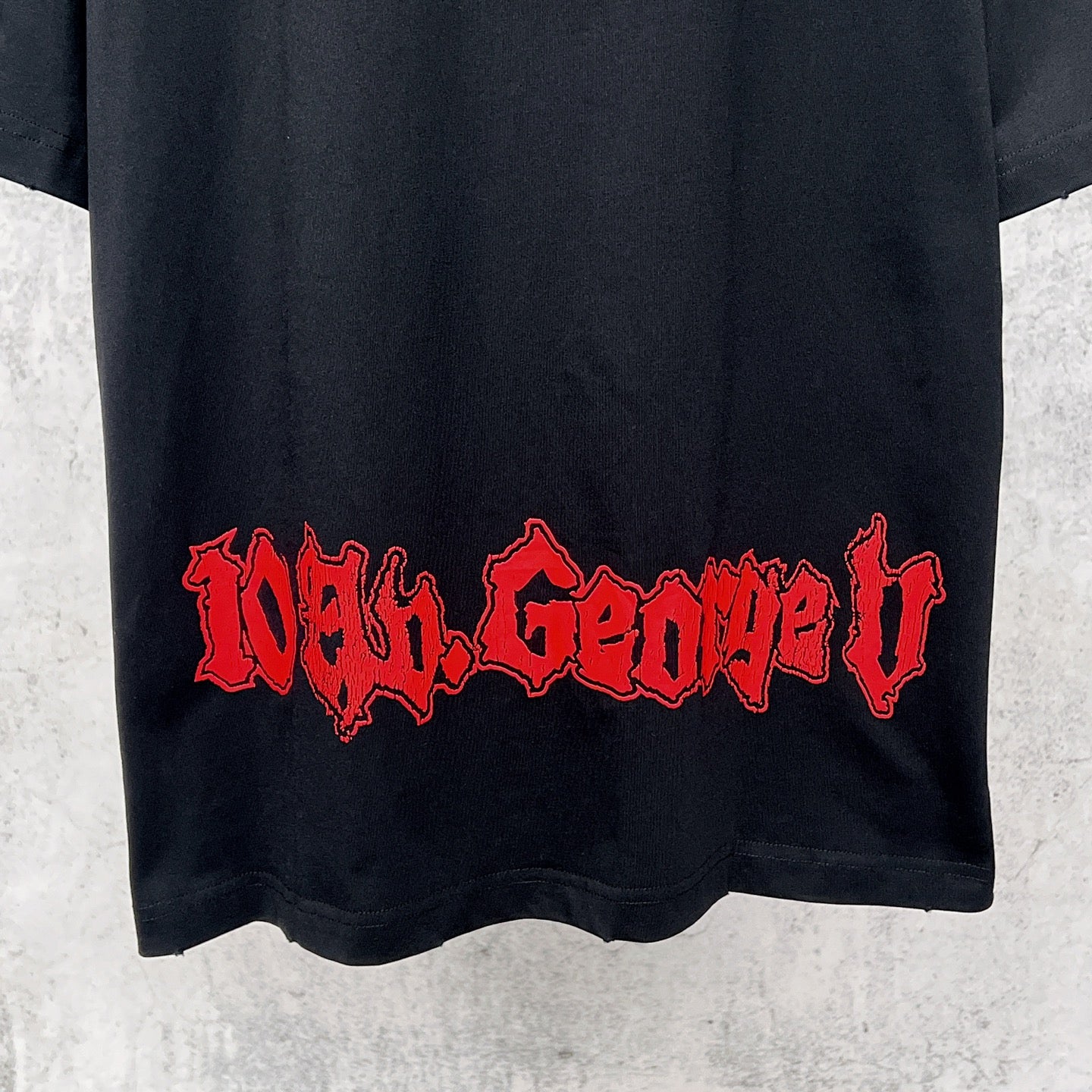 Graphic T-shirt back hem, black with red Gothic-style text