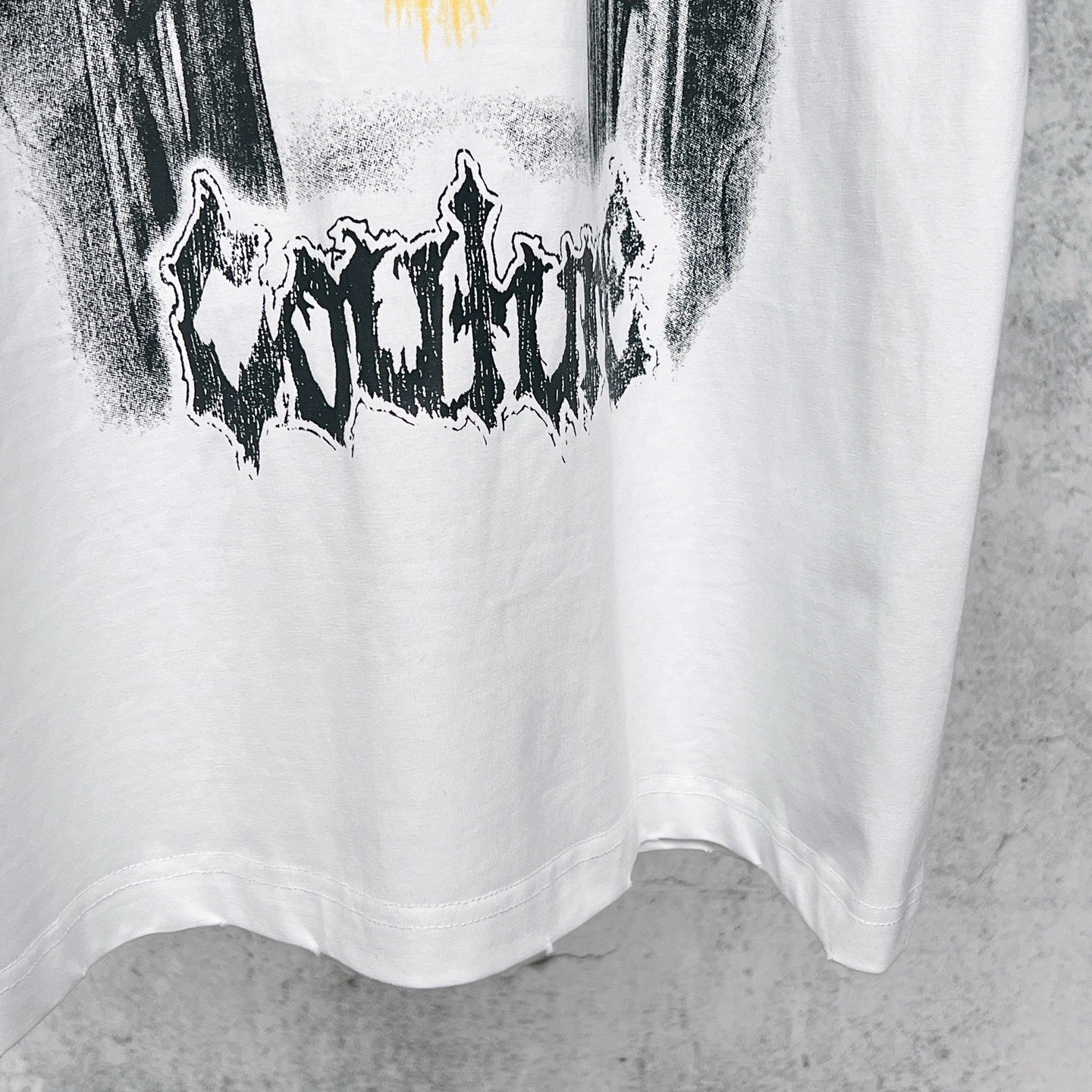 White T-shirt front lower half with distressed black graphic print