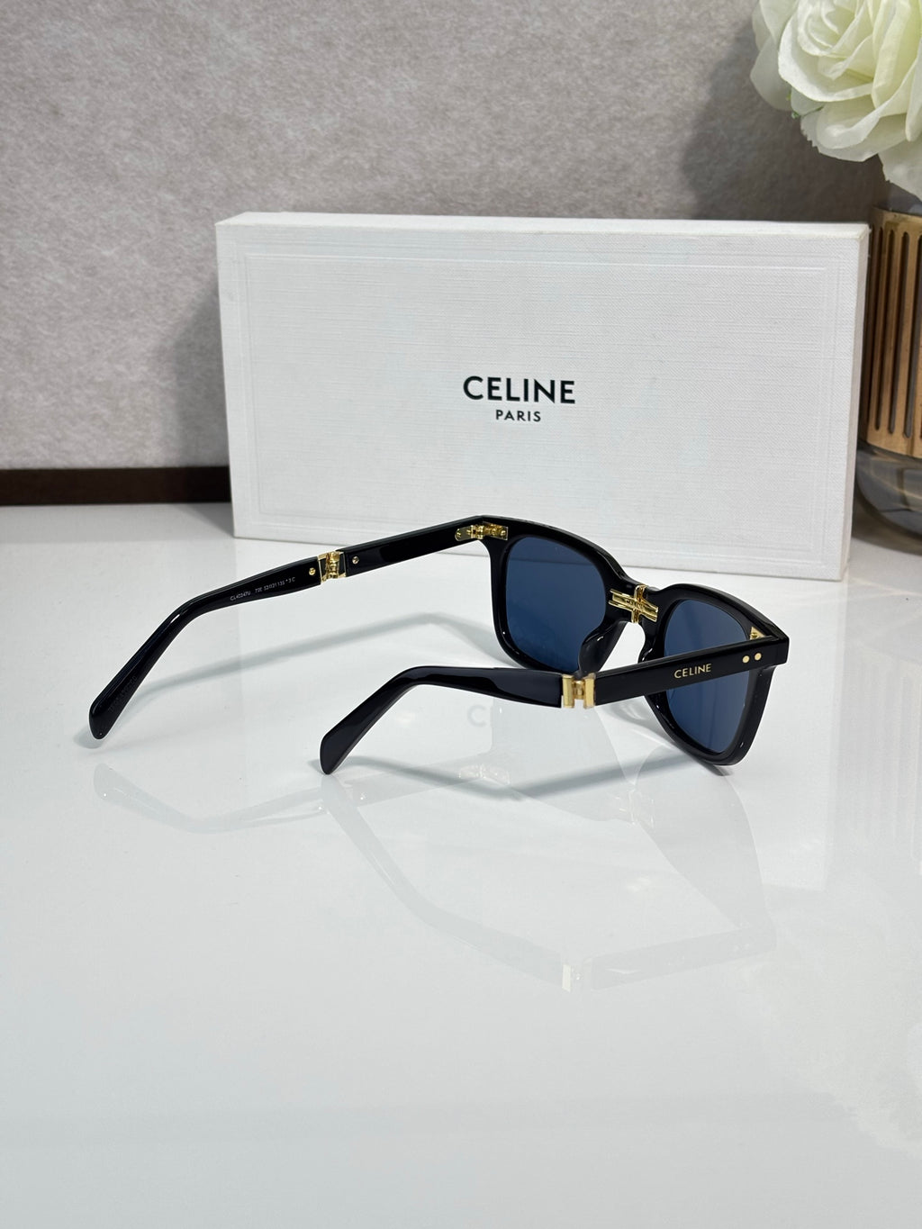 Celine blue-tinted sunglasses, black frame, gold hinge details