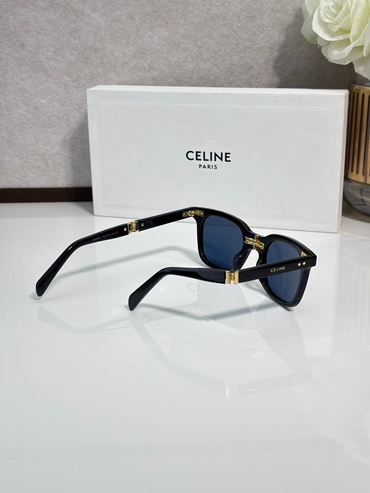 Celine blue-tinted sunglasses, black frame, gold hinge details
