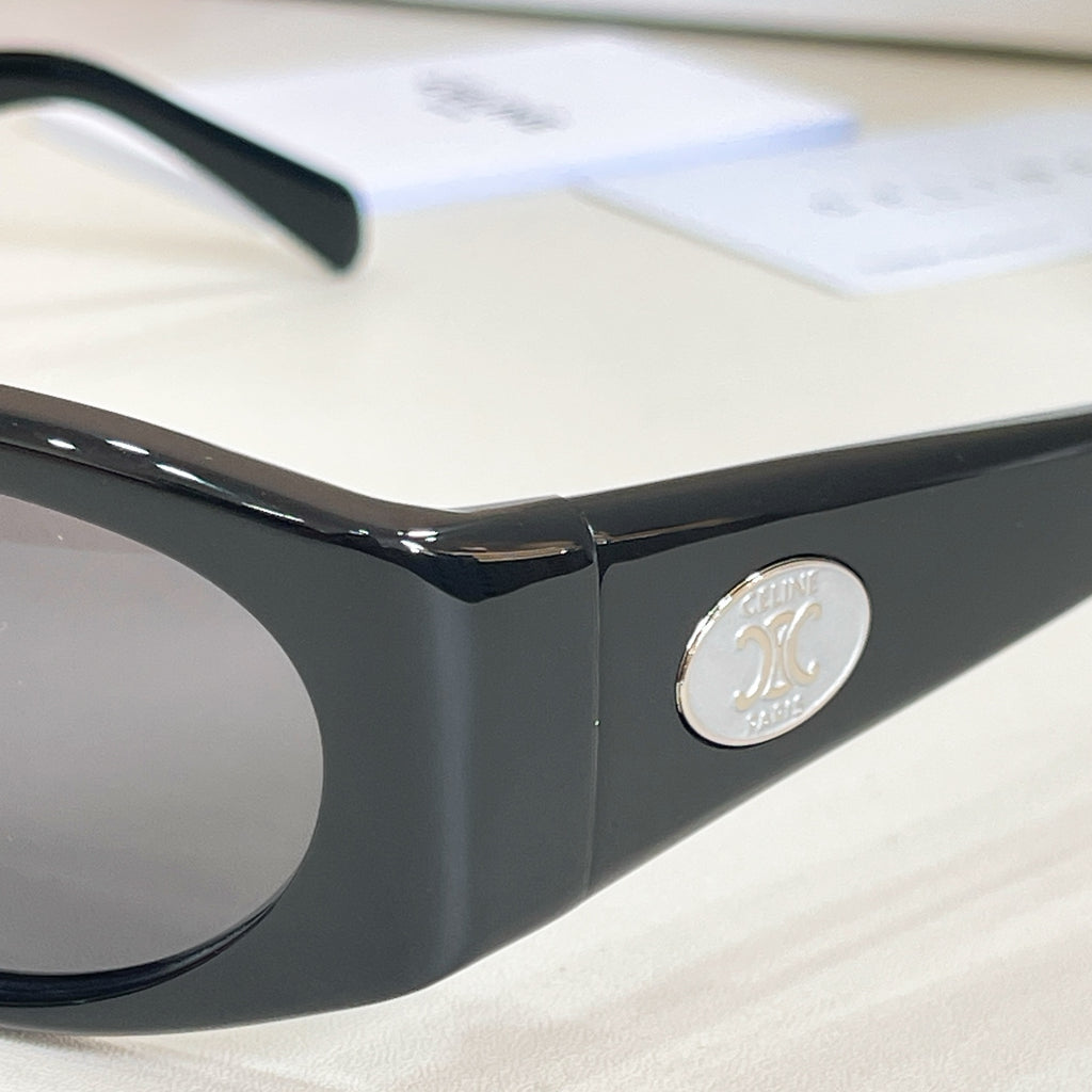Black sunglasses front with round silver “90” logo on temple