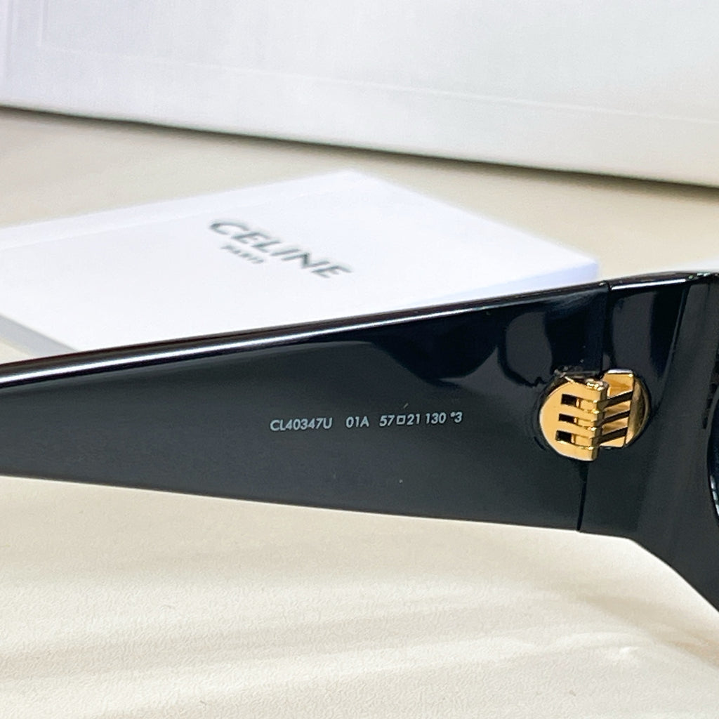 Black sunglasses sidearm with gold emblem and small model code text