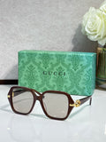 Gucci sunglasses with dark brown square frames and clear lenses, gold logo detail