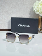 Chanel sunglasses with gold frame, dark purple gradient lenses, square shape