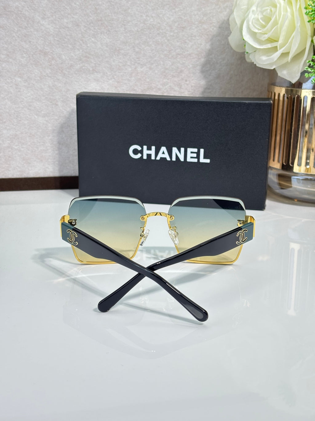 Chanel sunglasses with gold frame, blue gradient lenses, square corners