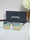 Chanel sunglasses with gold frame, teal gradient lenses, square corners