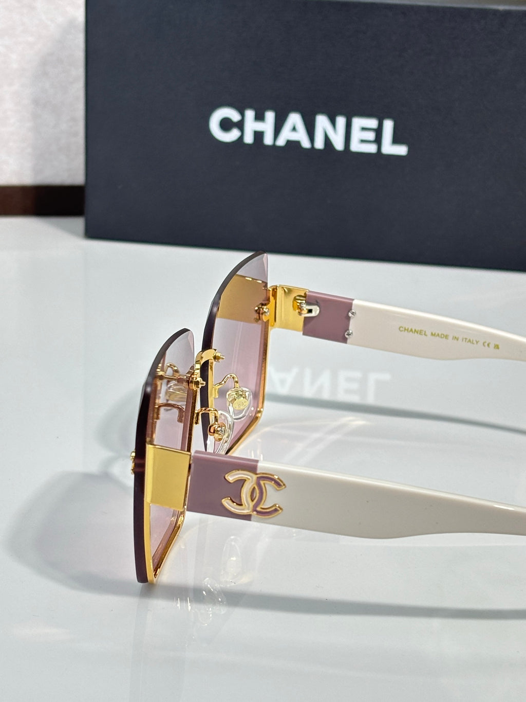 Chanel sunglasses closeup with gold hardware and clear lens highlights