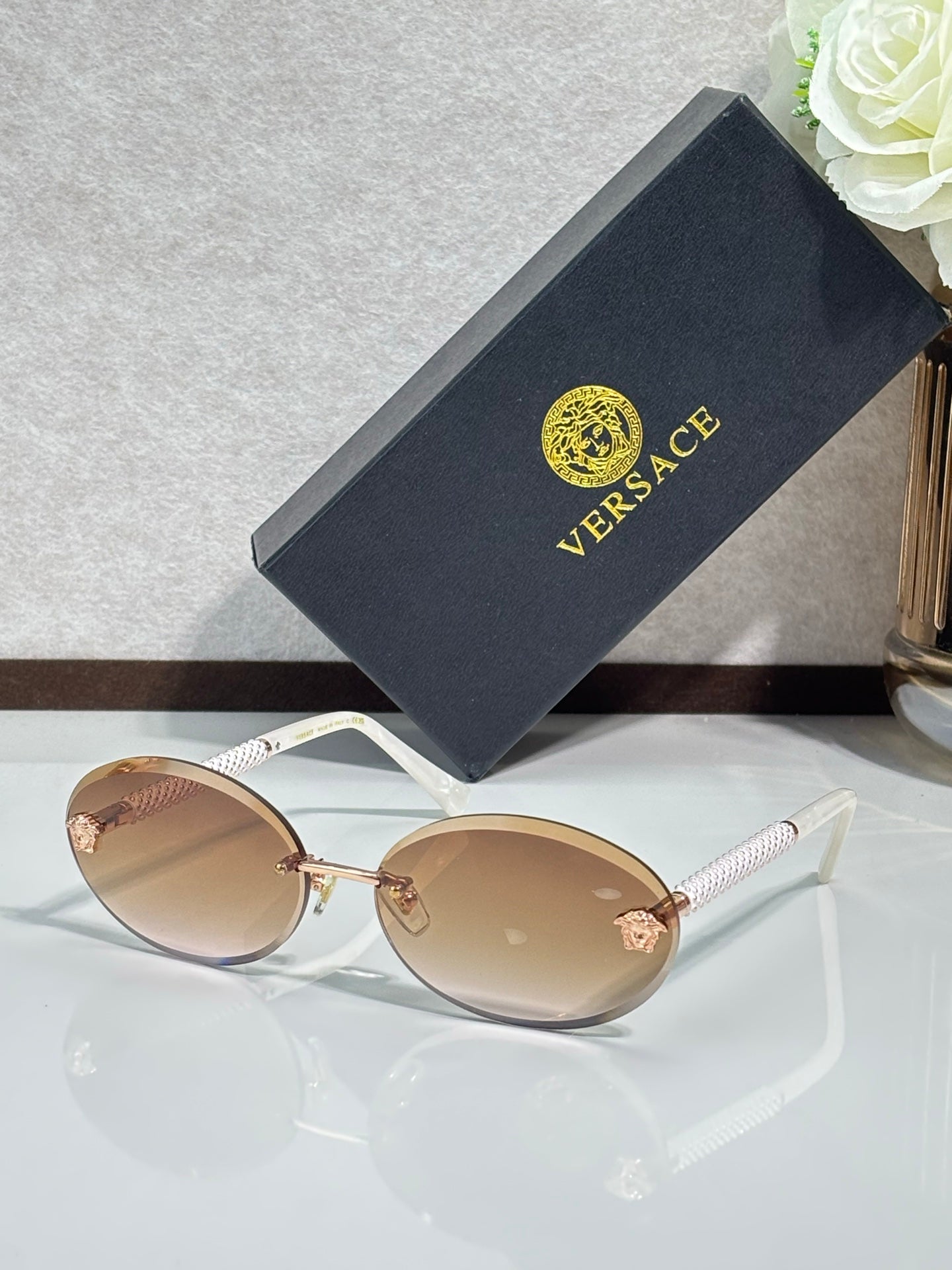 Versace sunglasses: round light frames, amber tinted lenses, gold-tone temples.