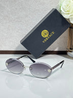 Versace sunglasses: round dark frames, silver-tone temples, gray tinted lenses.