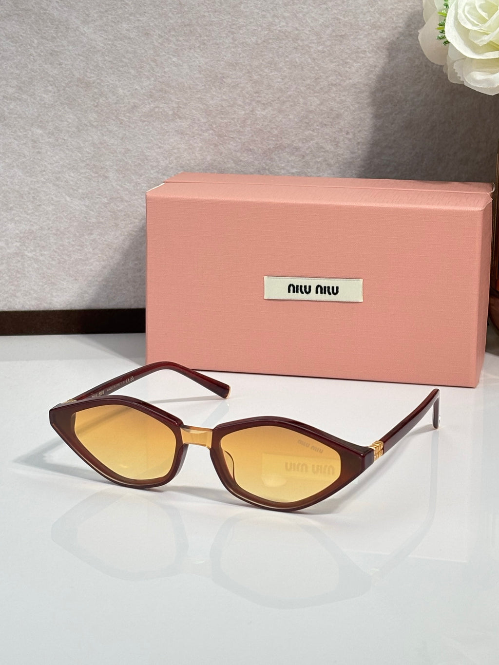 Tortoise-brown cat-eye sunglasses with amber lenses and gold-tone temple tips