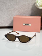 Dark tortoise cat-eye sunglasses with tinted lenses and gold-tone temple tips