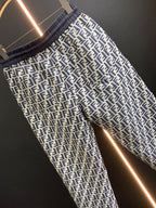 Black pants with white FF-style repeating pattern and elastic waistband, angled view