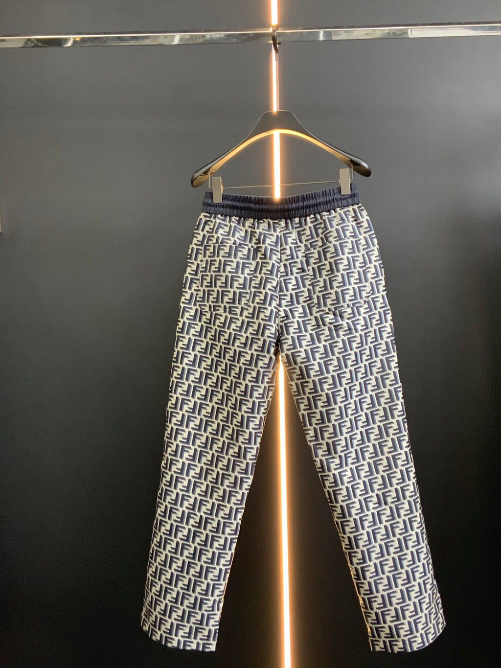 Pants in black with white FF-style repeating pattern and elastic waistband, full view