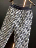 Black pants with white FF-style repeating pattern and elastic waistband, front close-up