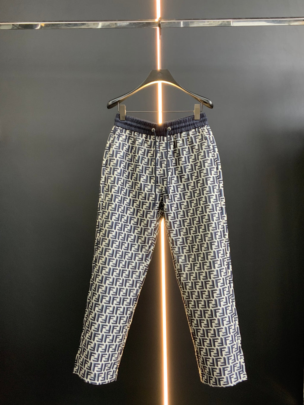 Black pants with white FF-style repeating pattern and elastic waistband, full view