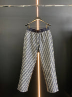 Black pants with white FF-style repeating pattern and elastic waistband, full view