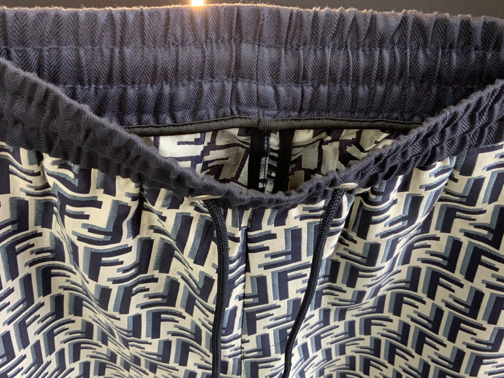 Elastic waistband with drawstring and FF-style repeating pattern, close-up