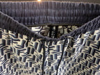 Elastic waistband with drawstring and FF-style repeating pattern, close-up